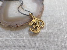 Load image into Gallery viewer, Ohm Aum Necklace - Brass Charm on Gunmetal Curb Chain - Reiki Zen Yoga Jewelry

